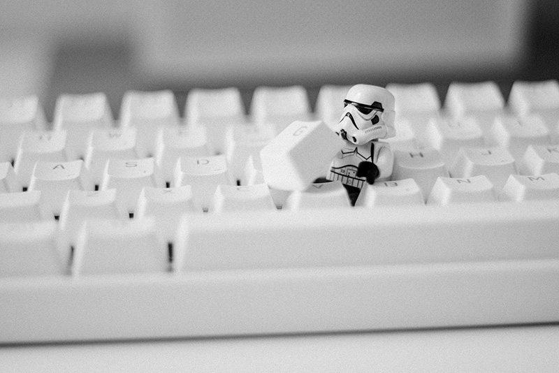 Stormtrooper hiding beneath the key of a keyboard