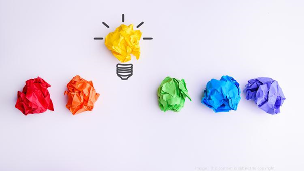 Color papers with idea lightbulb made of yellow one