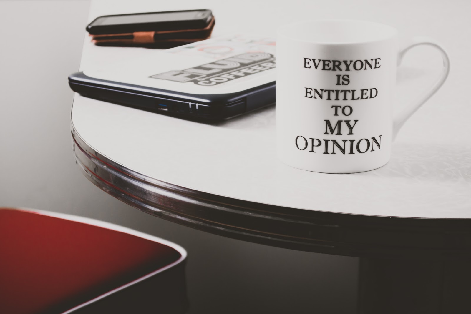 A cup with a caption saying "Everyone is entitled to my opinion"