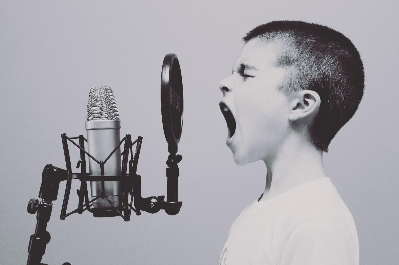 A teenager screaming into microphone