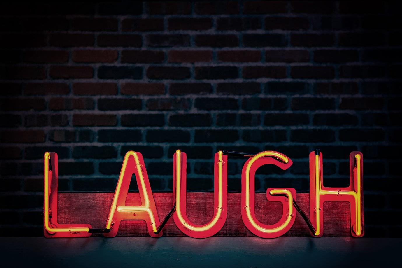 LAUGH red neon sign