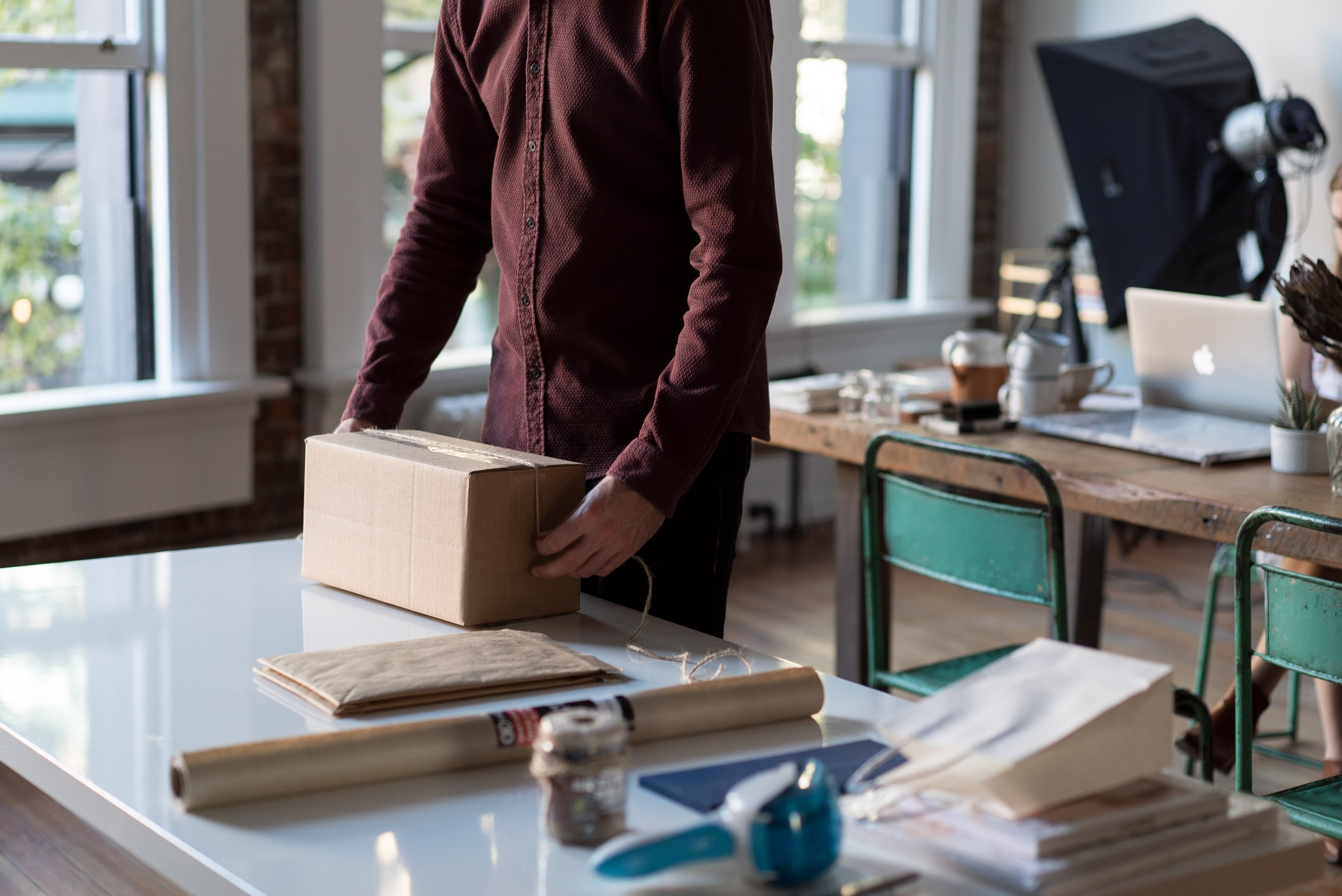 A man packing a cardboard box