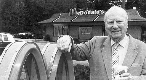 A photo of Richard McDonald beside his restaurant.