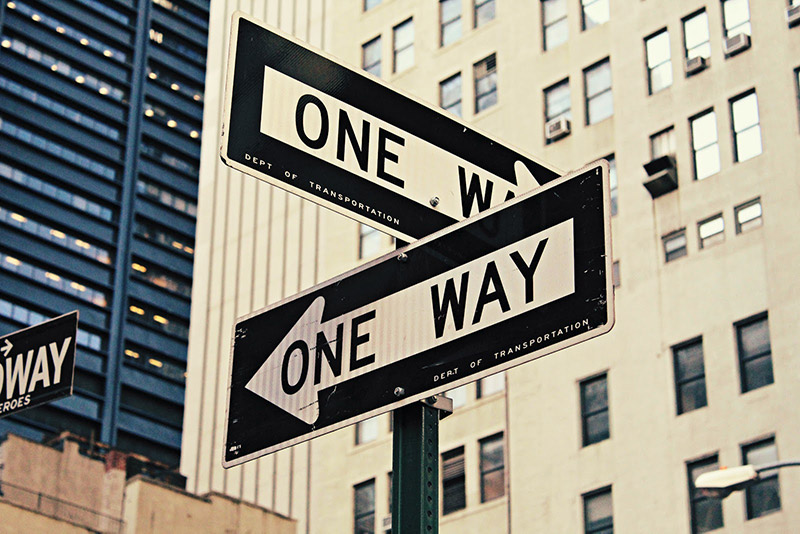 Two "One Way" street signs on the crossroad 