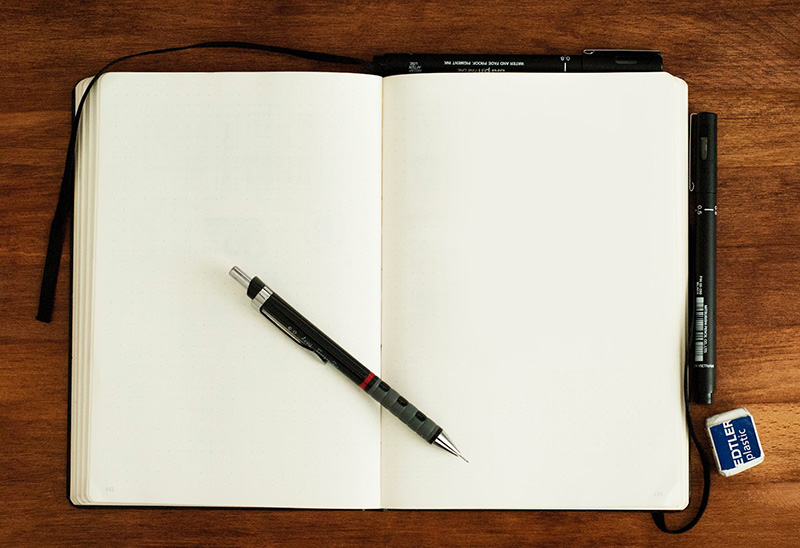 Blank notebook with pen and eraser