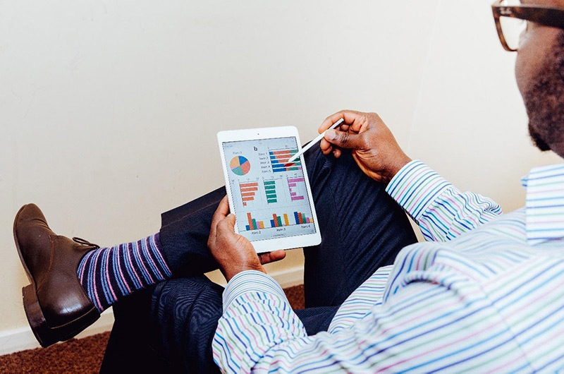 Man analizing data on his tablet