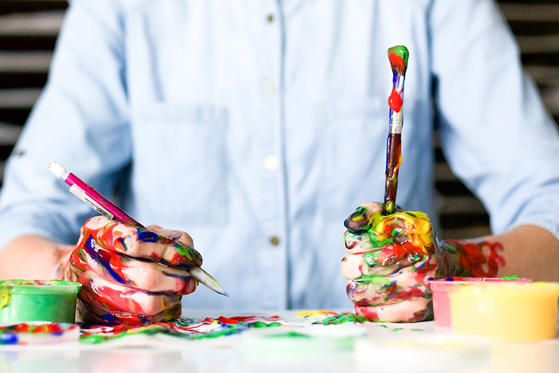 Man with paint all over his hands