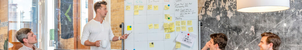 People in a meeting with a whiteboard