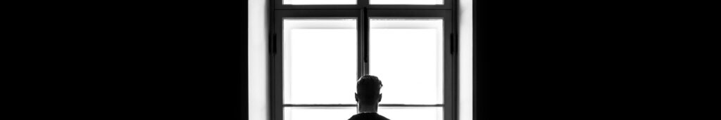 A man standing in a darkened room